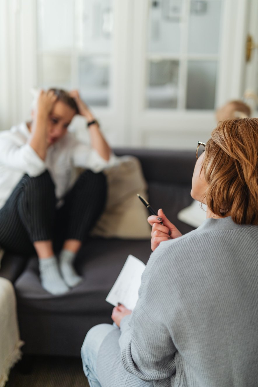 Worried Woman Taking Advice from Counsellor